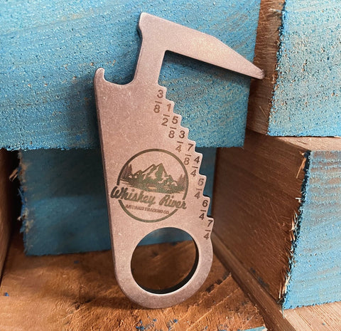 Whiskey River lumber gauge and bottle opener. This tool can easily fit in your pocket or on your key chain and is manufactured in America by DFM Toolworks in Chicago