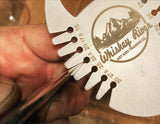 The whiskey river bottle opener and bevel gauge. Open your favorite beverage and measure the exact angle of the bevel of your axe head with this clean and machined tool. This picture is showing off how you can use this tool to measure the edge of your axe
