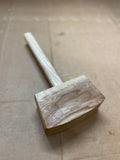 top down view of hand crafted, wooden carpenters mallet. This mallet is mad to hit your projects without leaving a mark