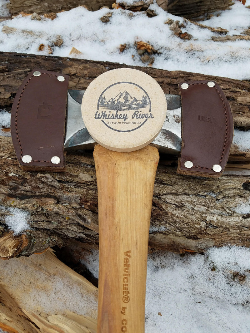 Medium grit, American made Whiskey River American Pioneer Pocket sharpening stone. Use this stone wet or dry. Easily restores the edge of your axe in no time! Pictured with the Council Tool saddle axe